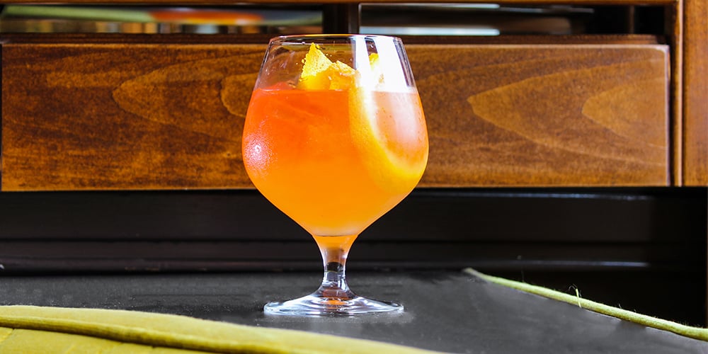 A cocktail with orange slices